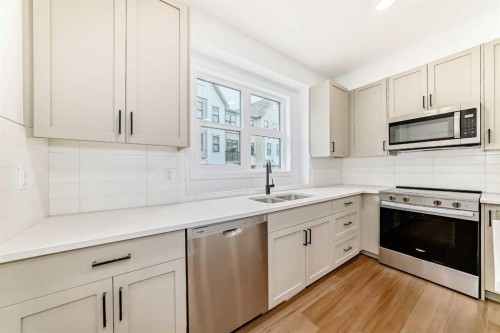 103-30 Rochester View Nw, Calgary, AB - Indoor Photo Showing Kitchen With Double Sink