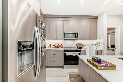 2214-6 Merganser Drive West, Chestermere, AB - Indoor Photo Showing Kitchen With Stainless Steel Kitchen With Upgraded Kitchen