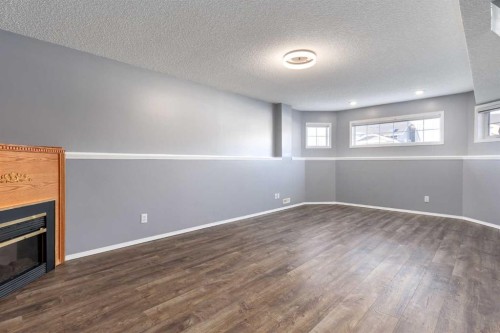 90 Elizabeth Way Se, Airdrie, AB - Indoor Photo Showing Other Room With Fireplace
