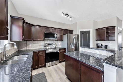 84 Cimarron Grove Close, Okotoks, AB - Indoor Photo Showing Kitchen With Stainless Steel Kitchen With Double Sink With Upgraded Kitchen