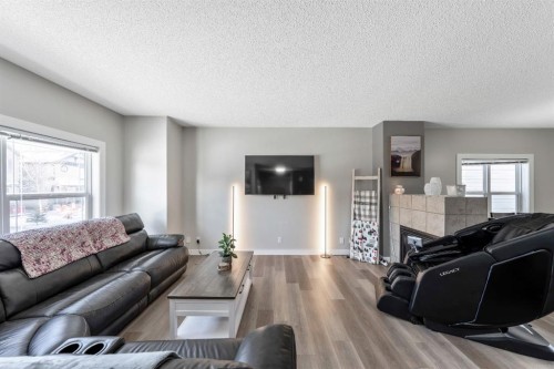 84 Cimarron Grove Close, Okotoks, AB - Indoor Photo Showing Living Room With Fireplace