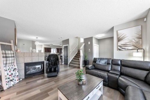 84 Cimarron Grove Close, Okotoks, AB - Indoor Photo Showing Living Room With Fireplace