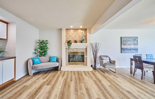 15 Hawkbury Close Nw, Calgary, AB - Indoor Photo Showing Living Room With Fireplace