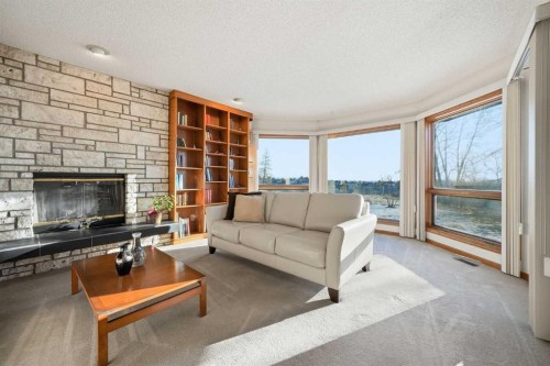 32 Woodgrove Crescent Sw, Calgary, AB - Indoor Photo Showing Living Room With Fireplace