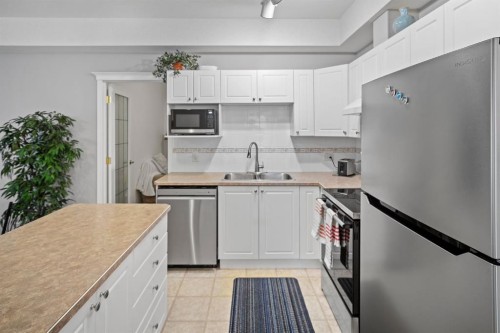 201-223 Tuscany Springs Boulevard Nw, Calgary, AB - Indoor Photo Showing Kitchen With Stainless Steel Kitchen With Double Sink