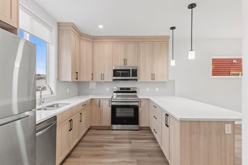 128 Fireside Way, Cochrane, AB - Indoor Photo Showing Kitchen With Double Sink