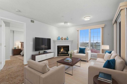 358-8535 Bonaventure Drive Se, Calgary, AB - Indoor Photo Showing Living Room With Fireplace