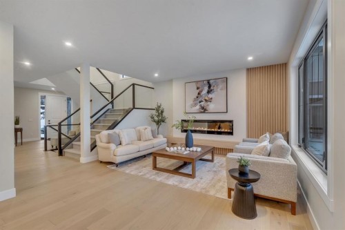 12 Spring Creek Point Sw, Calgary, AB - Indoor Photo Showing Living Room With Fireplace