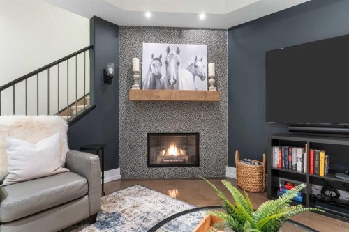 267 Coopers Hill Sw, Airdrie, AB - Indoor Photo Showing Living Room With Fireplace