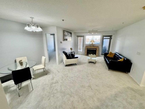 210-4507 45 Street Sw, Calgary, AB - Indoor With Fireplace