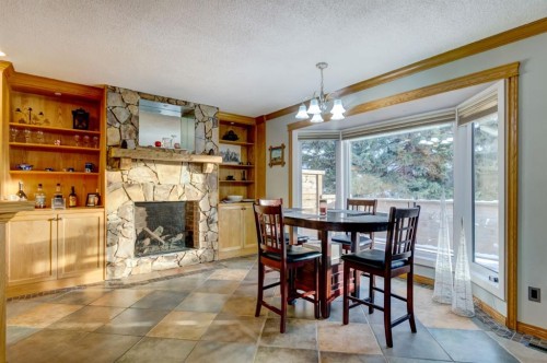 1408 106 Avenue Sw, Calgary, AB - Indoor Photo Showing Dining Room With Fireplace