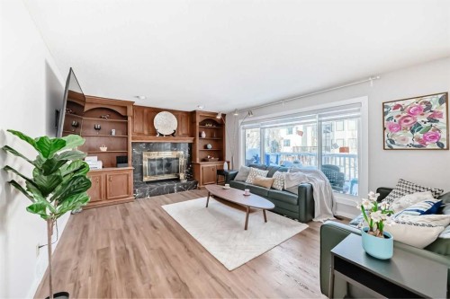 8328 Edgevalley Drive Nw, Calgary, AB - Indoor Photo Showing Living Room With Fireplace