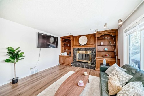 8328 Edgevalley Drive Nw, Calgary, AB - Indoor Photo Showing Living Room With Fireplace