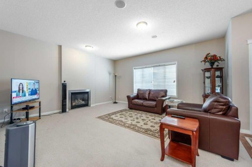 1119 Panamount Boulevard Nw, Calgary, AB - Indoor Photo Showing Living Room With Fireplace