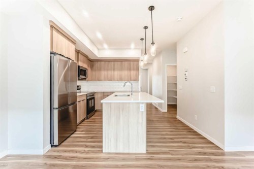 129-42 Cranbrook Gardens Se, Calgary, AB - Indoor Photo Showing Kitchen With Stainless Steel Kitchen