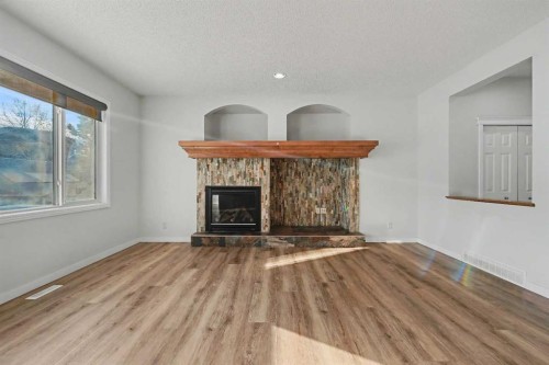 134 Autumn Gardens Se, Calgary, AB - Indoor Photo Showing Living Room With Fireplace