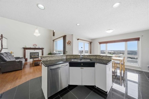 62 Hampstead Gardens Nw, Calgary, AB - Indoor Photo Showing Kitchen With Fireplace With Double Sink
