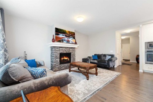 229 Kingsbury Close Se, Airdrie, AB - Indoor Photo Showing Living Room With Fireplace