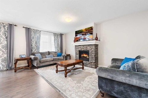 229 Kingsbury Close Se, Airdrie, AB - Indoor Photo Showing Living Room With Fireplace