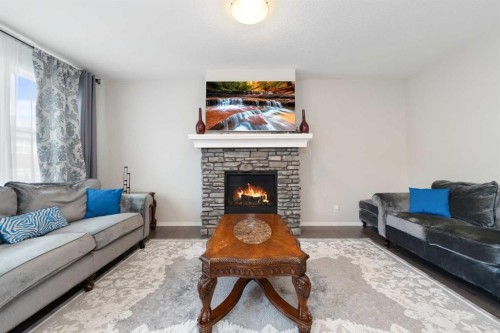 229 Kingsbury Close Se, Airdrie, AB - Indoor Photo Showing Living Room With Fireplace