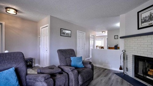 78 Athabasca Crescent, Crossfield, AB - Indoor Photo Showing Living Room With Fireplace
