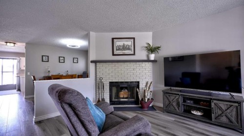 78 Athabasca Crescent, Crossfield, AB - Indoor Photo Showing Living Room With Fireplace