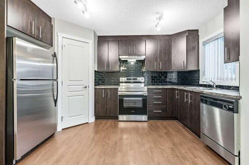 1305-2445 Kingsland Road Se, Airdrie, AB - Indoor Photo Showing Kitchen With Double Sink