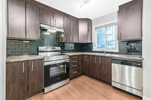 1305-2445 Kingsland Road Se, Airdrie, AB - Indoor Photo Showing Kitchen With Double Sink