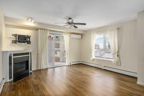 2312-279 Copperpond Common Se, Calgary, AB - Indoor Photo Showing Living Room With Fireplace