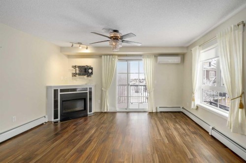 2312-279 Copperpond Common Se, Calgary, AB - Indoor Photo Showing Living Room With Fireplace