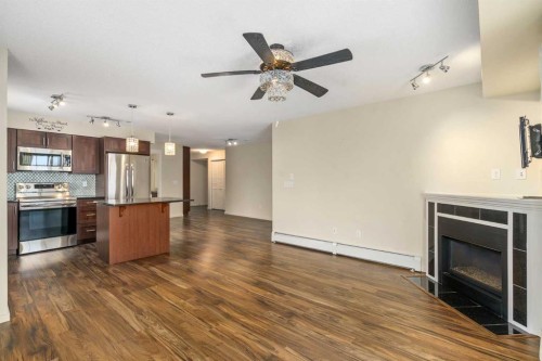 2312-279 Copperpond Common Se, Calgary, AB - Indoor Photo Showing Kitchen With Fireplace