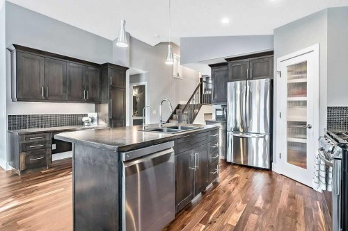 605 Sunrise Close, Diamond Valley, AB - Indoor Photo Showing Kitchen With Stainless Steel Kitchen With Double Sink With Upgraded Kitchen