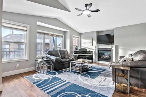 605 Sunrise Close, Diamond Valley, AB - Indoor Photo Showing Living Room With Fireplace