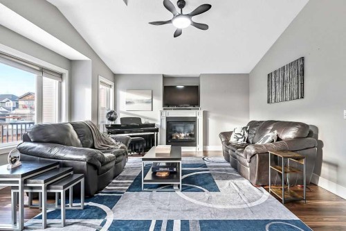 605 Sunrise Close, Diamond Valley, AB - Indoor Photo Showing Living Room With Fireplace
