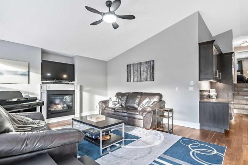 605 Sunrise Close, Diamond Valley, AB - Indoor Photo Showing Living Room With Fireplace