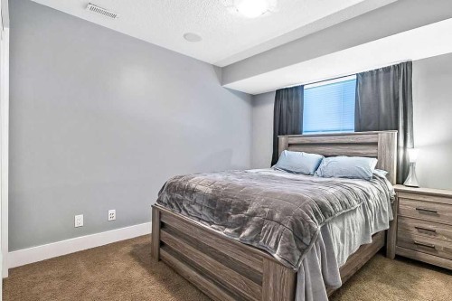 605 Sunrise Close, Diamond Valley, AB - Indoor Photo Showing Bedroom