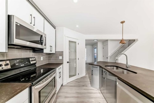 99 Saddlecrest Way Ne, Calgary, AB - Indoor Photo Showing Kitchen With Stainless Steel Kitchen With Double Sink With Upgraded Kitchen