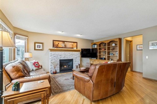 75 Shawnee Crescent, Calgary, AB - Indoor Photo Showing Living Room With Fireplace