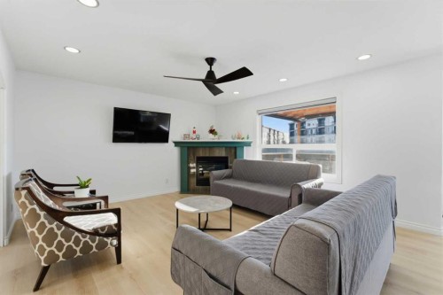 325 Bayside Place Sw, Airdrie, AB - Indoor Photo Showing Living Room With Fireplace