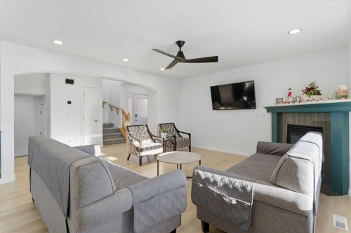 325 Bayside Place Sw, Airdrie, AB - Indoor Photo Showing Living Room With Fireplace