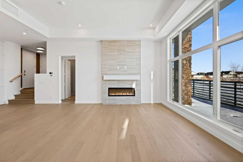 102-140 Marina Cove Se, Calgary, AB - Indoor With Fireplace