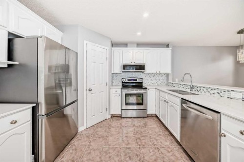 95 Hidden Creek Rise Nw, Calgary, AB - Indoor Photo Showing Kitchen With Stainless Steel Kitchen With Double Sink With Upgraded Kitchen