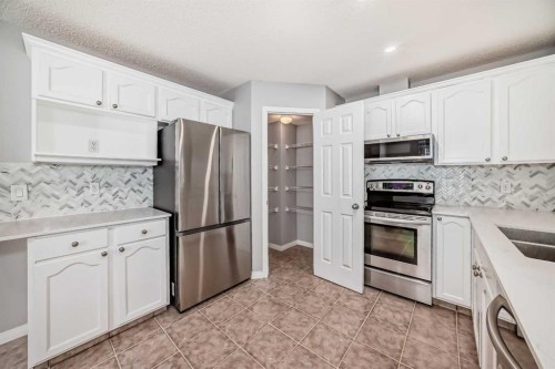 95 Hidden Creek Rise Nw, Calgary, AB - Indoor Photo Showing Kitchen With Stainless Steel Kitchen With Double Sink