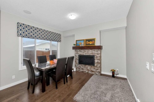 1072 Cornerstone Street Ne, Calgary, AB - Indoor Photo Showing Dining Room With Fireplace