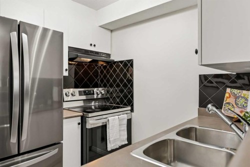 1208-2395 Eversyde Avenue Sw, Calgary, AB - Indoor Photo Showing Kitchen With Stainless Steel Kitchen With Double Sink