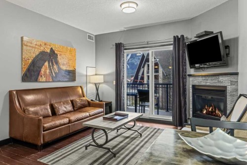 322-901 Mountain Street, Canmore, AB - Indoor Photo Showing Living Room With Fireplace