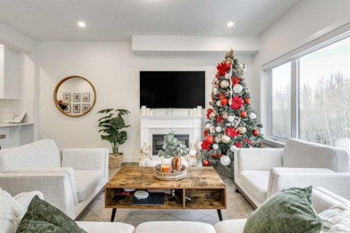 156 Crestridge Common Sw, Calgary, AB - Indoor Photo Showing Living Room With Fireplace