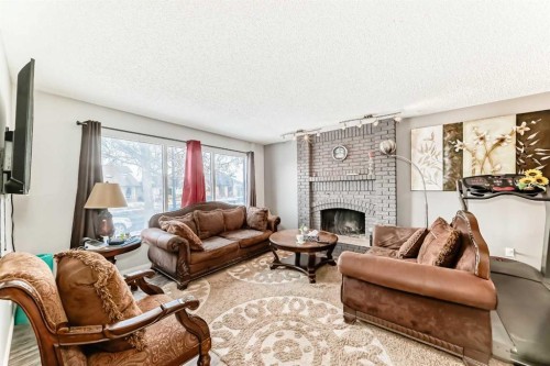 6944 Temple Drive Ne, Calgary, AB - Indoor Photo Showing Living Room With Fireplace