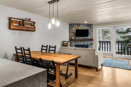 1-1061 Evergreen Circle, Canmore, AB - Indoor Photo Showing Dining Room With Fireplace