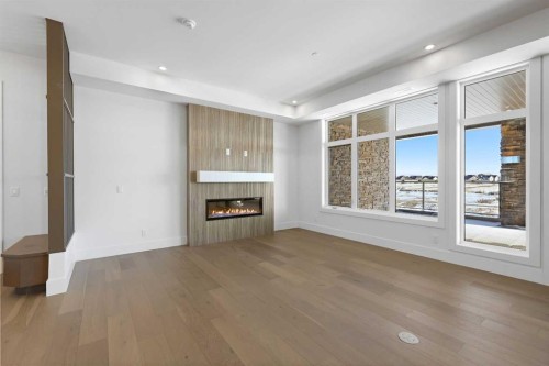 202-140 Marina Cove Se, Calgary, AB - Indoor With Fireplace